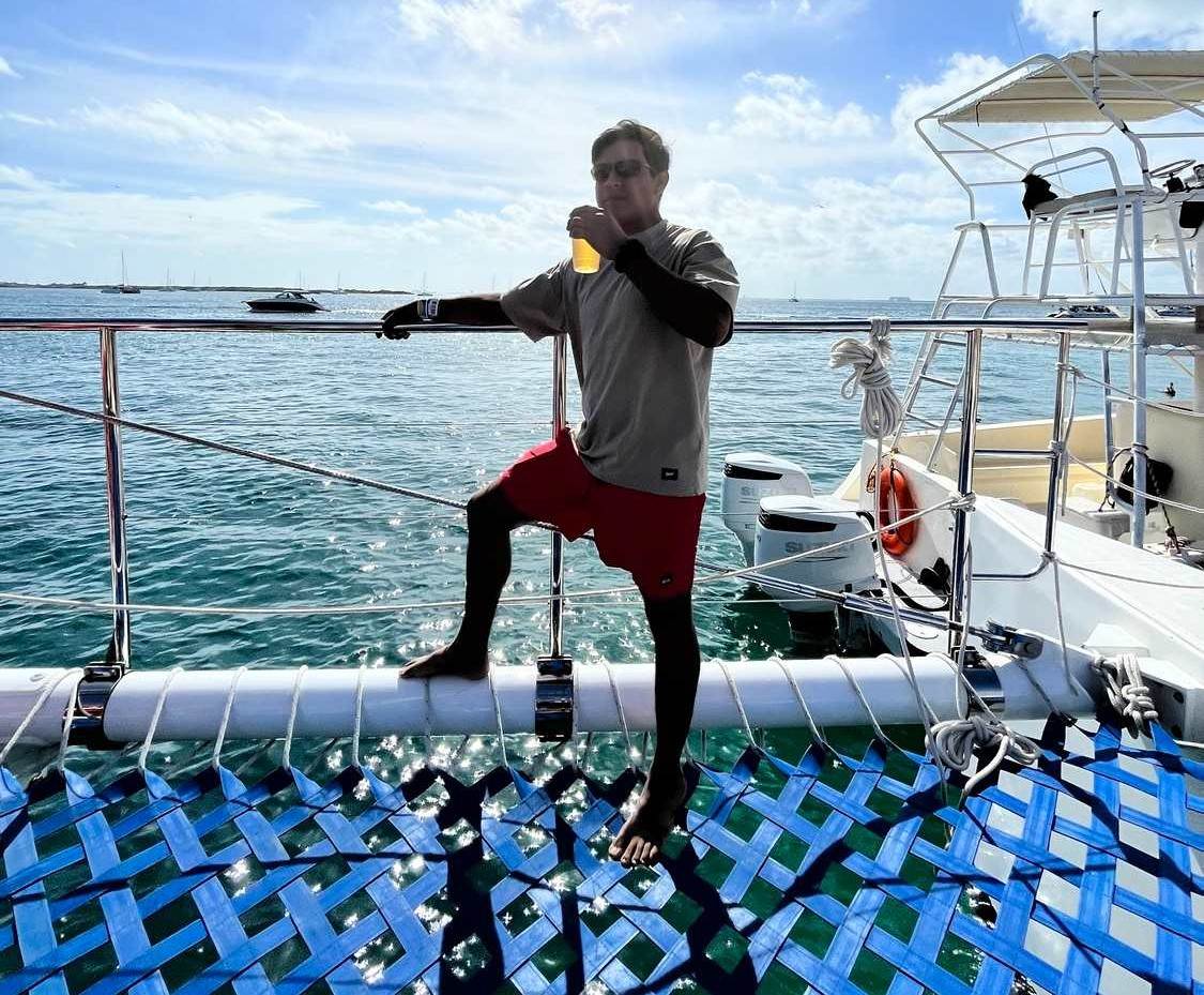 boy on a catamaran tour to isla mujeres